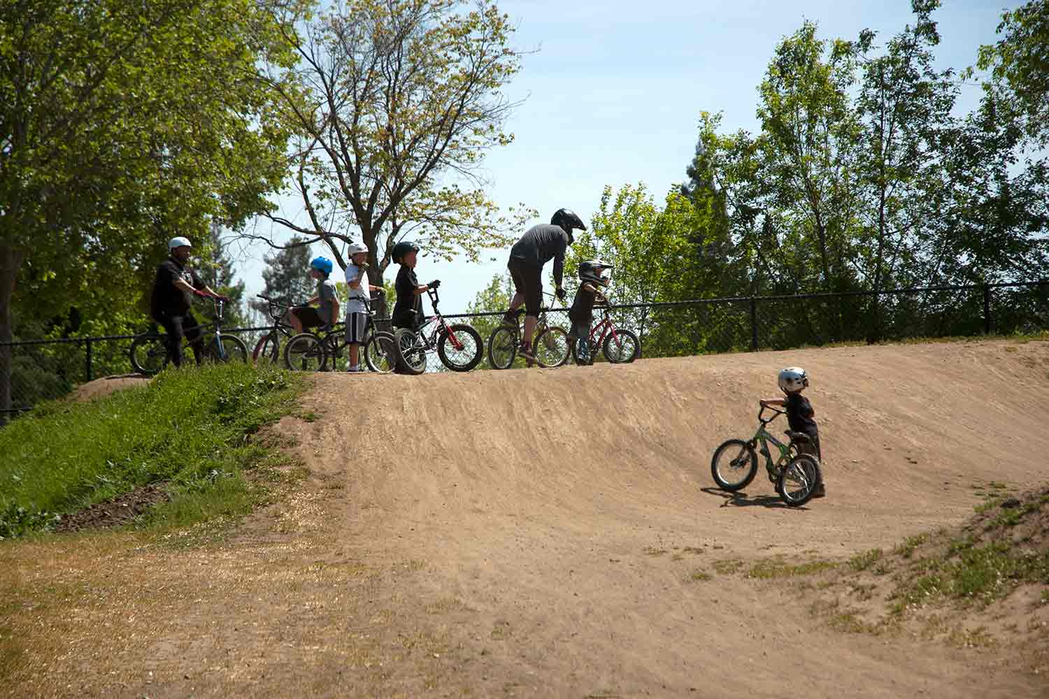 Big and Little line up to ride the berms at Calabazas Bike Park, San Jose, California
