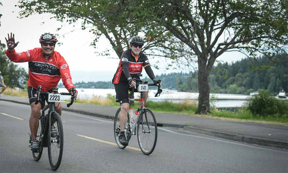 Photo of Gabe Castillo & Dan Shyrock riding on the road during STP. Cascade Bicycle Club photo.