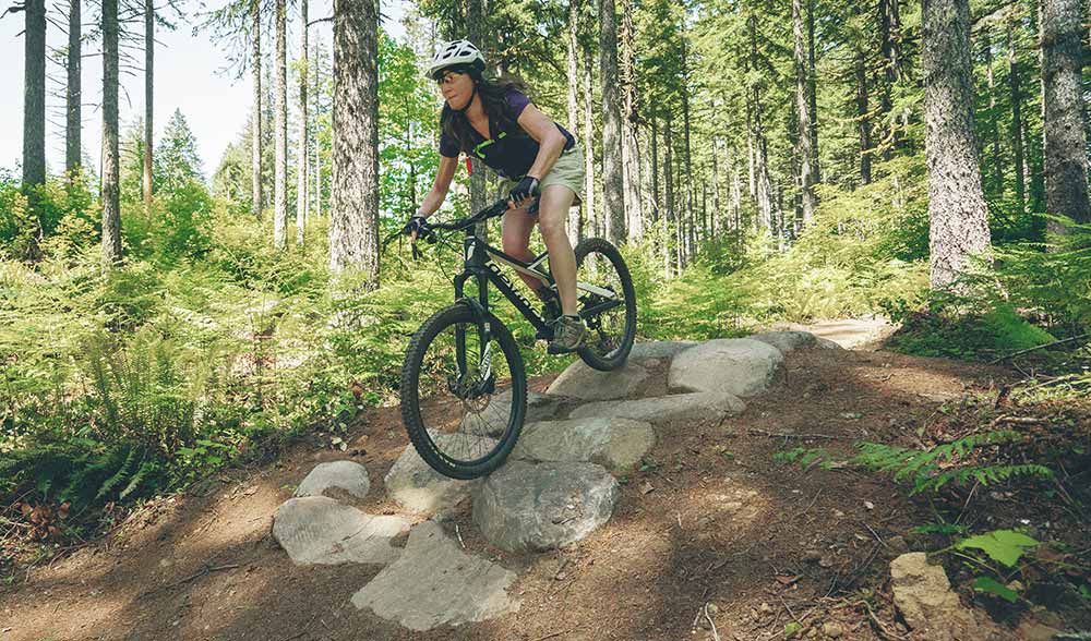 photo of a woman bombing down a trail.